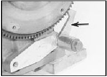 8.10 Use the tool shown to lock the flywheel ring gear and prevent the