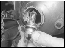 8.7b . . . and withdraw the headlight bulb